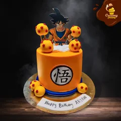 A powerful cake for a Dragon Ball Z fan. This orange cake is decorated with the iconic Dragon Balls and features a topper of Goku, ready for action.