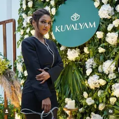 A guest at the 'Kuvalyam' brand launch. The floral wall provided a beautiful and professional photo opportunity, ensuring great visibility for the brand on social media.