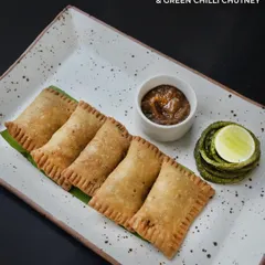 A classic from Hyderabad, our Keema Lukhmi are crisp, savory pastries filled with spiced minced meat. We serve them with a tangy dates and green chilli chutney for a perfect sweet and spicy combination.