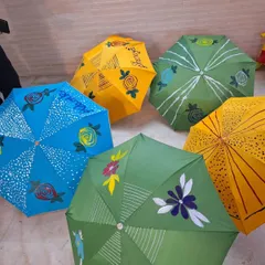 A colourful collection of finished umbrellas from one of our workshops. Each one is a unique piece of art, reflecting the personality of the child who painted it.