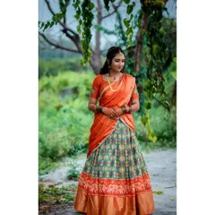 A full-length portrait of a bride-to-be in her beautiful engagement outfit, set against a natural, green background.