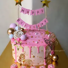 A beautiful pink drip cake personalized with the name "Bency." The combination of a birthday banner, flowers, and butterflies makes it extra special.