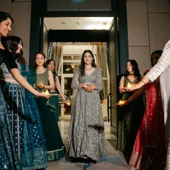 A beautiful shot of our bride making her entrance, welcomed by her bridesmaids holding candles. We help stage these moments for maximum emotional and visual impact.