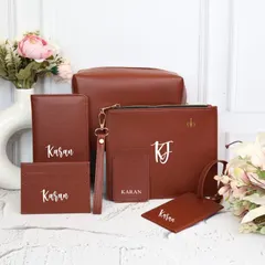 The complete personalized travel kit in a rich tan brown. Each piece, from the passport holder to the utility pouch, is customized with a name and initials, making it a sophisticated and practical gift for any traveler.