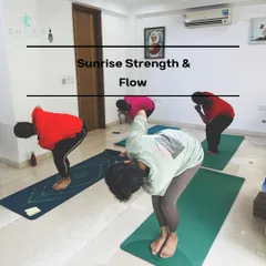Our Sunrise Strength & Flow class is the perfect way to start the day. Here, students are in Parivrtta Utkatasana (Revolved Chair Pose), a powerful twist that detoxifies the body and builds core strength.