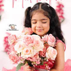 A sweet portrait of the birthday girl smelling a bouquet of pink roses. The 'Petal Perfume' text adds a whimsical touch to this lovely, soft image.