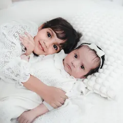 The bond between siblings is pure magic. I focus on capturing that gentle, protective love, like this quiet moment between an older sister and her new baby sibling.