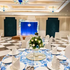 A close-up of a table setting in my banquet hall, featuring crisp linens, elegant floral arrangements, and perfectly folded napkins. I pride myself on the meticulous attention to detail that makes every celebration flawless.