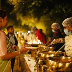 A guest being served at my elegant buffet. My professional staff ensures every guest is attended to with courtesy and care, maintaining hygiene and service standards.