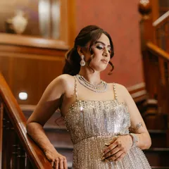 Our client looks stunning in a rented American diamond necklace, perfectly complementing her sequined gown for a reception party.