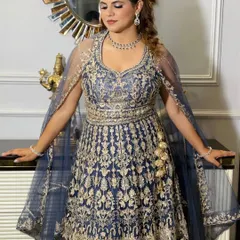 The full look for this glamorous reception. The client looks confident and beautiful in her heavily embroidered gown, with makeup and hair that complete the ensemble.