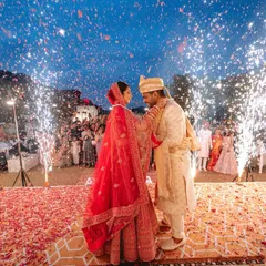 The magical moment of the varmala exchange, illuminated by a shower of fireworks. This is the kind of grand, unforgettable shot that defines a wedding celebration.