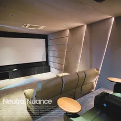 Modern elegance defines this home theater in Noida, which features a neutral color palette and sophisticated architectural lighting. The combination of a comfortable beige sofa and premium recliners offers flexible seating options for any gathering.