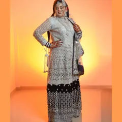 A full-length shot displaying the bride's entire magnificent outfit. This pose shows off the intricate details of her lehenga and her confident stance on her special day.