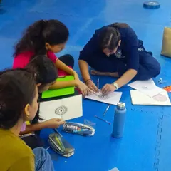 I love these moments of quiet collaboration and guidance. Here, I’m helping a young student with the finer details of her pattern, showing her how to build the design step by step.