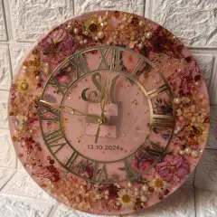 Another angle of the custom floral clock, showing how the light catches the gold details and the texture of the preserved flowers.