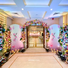 We designed this vibrant and welcoming entrance for a Haldi ceremony, using a spectrum of colorful flowers and whimsical butterfly details to create a captivating and joyful atmosphere for guests.