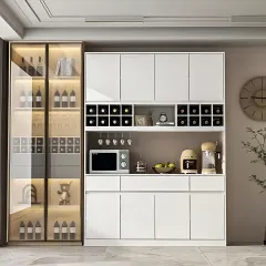 A modern bar and crockery unit in white, with dedicated wine racks, glass holders, and a countertop for serving.