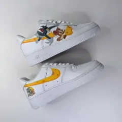A full view of the Tom and Jerry custom sneakers, showing both the action-packed outer side and the cheesy inner side.