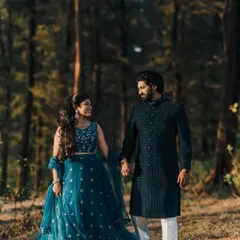 A closer shot of the couple, showing the texture of the sherwani and the details of her lehenga.