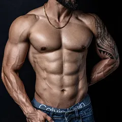 A close-up of a client's physique after a 100-day body recomposition. The abdominal definition and vascularity are on full display.
