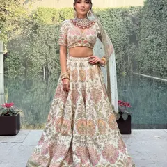 Another perspective of this gorgeous Sabyasachi lehenga, highlighting its flow and grace against a natural, green backdrop.