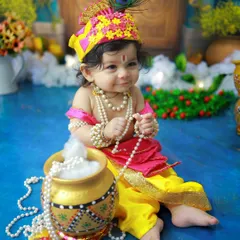 A thoughtful little Kanha, holding his pearl necklace and sitting by a pot of 'makhan'. I pay close attention to every detail, from the jewelry to the props, to make these portraits authentic and precious.