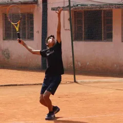 Perfect form on the serve. This young athlete shows great extension and power, skills honed through dedicated practice and competitive play.
