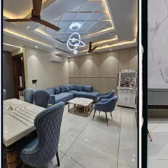 Another angle of the same living room, showing the relationship between the seating area and the dining table. The consistent color palette and materials create a unified and spacious feel.