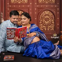Sharing a quiet moment together, this couple reads a book to their unborn baby. This pose adds a personal and sentimental layer to their traditional maternity session, capturing their anticipation and love.