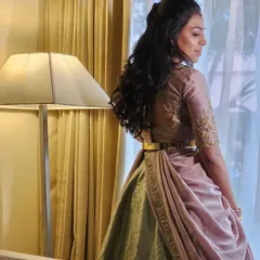 The back of Dr. Tushara's blouse features a beautiful cutout design, adding a modern touch to her outfit.