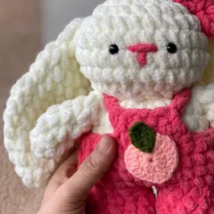 A closer look at the Pookie Bunny, held in hand to show her size and soft texture. The peach detail on her overalls is one of my favorite little touches.