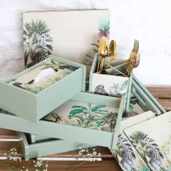 A stacked display of our Savanna collection, including trays, a tissue box, and a cutlery holder. The cohesive jungle print and soft green hue make it easy to create a stylish, layered look.