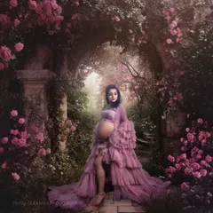 A fine art masterpiece set in a secret garden. The mother-to-be is surrounded by an arch of pink roses, creating a breathtakingly beautiful and romantic maternity portrait.