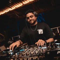 A smile on my face while I spin tracks at a Goa party. The beachside setting is perfect for my blend of Reggaeton, House, and commercial hits.
