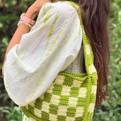Our handmade checkered crochet shoulder bag, styled for a casual day out. This trendy and spacious bag adds a pop of color and a unique touch to any outfit.
