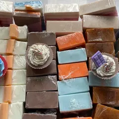 My workspace filled with freshly made soaps. This is what it looks like when I'm restocking my most popular camel milk and shea butter bars, including some cute cupcake designs.