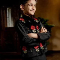 Stealing hearts and the spotlight. Our black velvet Bundi jacket with hand-embroidered red roses offers a bold contrast, creating a look that is both classic and striking.
