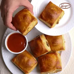 This is one of our most iconic snacks, the classic savory puff. Each one has a golden, flaky pastry shell that gives way to a delicious, warm filling. It's the perfect companion for your shaam ki chai or a quick bite on the go.