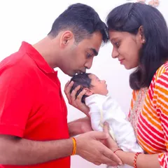 A father's gentle kiss on his newborn's head. We capture these simple, powerful moments of connection during our in-home newborn photography sessions.