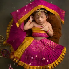 Our little goddess is ready for Navratri. Dressed in a beautiful pink and yellow ghagra choli, this 25-day-old baby brings so much blessing to the festive season.
