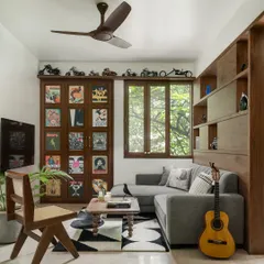 We love adding a cheeky surprise to our designs. In this family living room, what looks like a wall of curated movie and music posters is actually a hidden bar, perfect for entertaining.