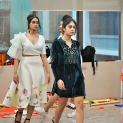 Models on the runway during our showcase at the Tvaran Fest. The look on the left features our ruffled sleeve top with a floral applique skirt, while the right shows a velvet embroidered tunic dress.