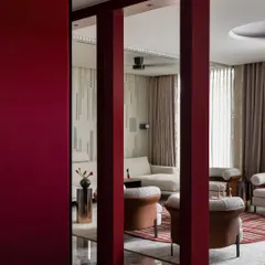 We used these deep crimson-cherry frames to create a deliberate visual threshold between the foyer and the living area. This architectural element helps define the transition between spaces while adding a layer of drama and sophistication to the open layout.