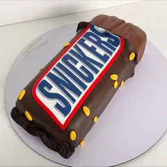 You're not you when you're hungry. This cake is sculpted to look exactly like a Snickers bar, but the real challenge was making it taste like one too, with layers of caramel, roasted peanuts, and chocolate ganache.
