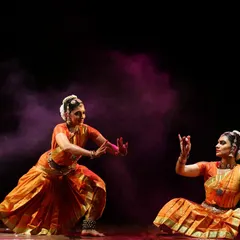 A dynamic duet moment from the production *Sarvasya*. The interplay between two dancers creates a unique energy, allowing for complex storytelling and visual harmony.