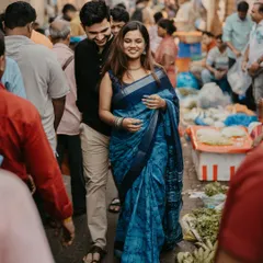 A candid moment captured in the vibrant chaos of Dadar flower market, showing the couple's connection amidst the bustling crowd.