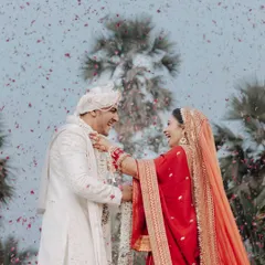 This is the kind of pure, unscripted joy we live to create. A candid varmala moment captured under a shower of rose petals, celebrating a love that's real and beautiful.
