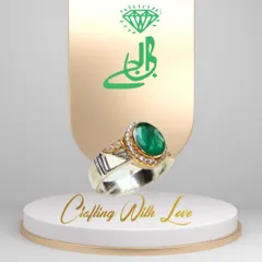 This ring is a perfect example of classic elegance. A beautiful green emerald is set in a two-tone band of silver and 18k gold, surrounded by a delicate halo of diamonds. It's a design that is both opulent and refined.