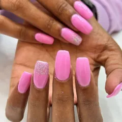 A fun and feminine design featuring bright pink gel extensions with silver glitter accent nails. This is a great way to add some sparkle to your favorite color.